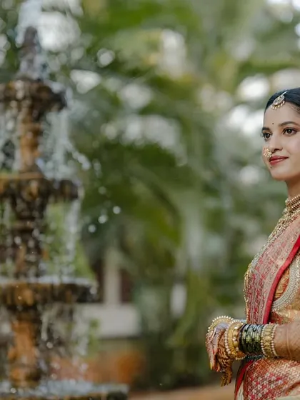 My beautiful client-turned-family, Chethana, looks timeless in this white and pink Kanchipuram saree. I designed a heavily handcrafted bridal blouse with intricate zardozi work to complement the saree's elegance for her special day.