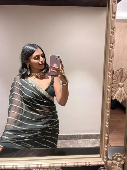 Playing with angles in the mirror. This shot shows how the light catches the metallic stripes on the saree, adding a subtle shimmer to the look.