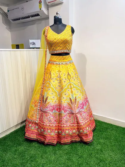 This is a full shot of the printed yellow Haldi lehenga, showing the beautiful flare of the skirt and the matching net dupatta. It's a complete, ready-to-rent outfit.