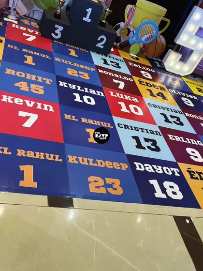 The custom-printed floor at this sports party was a huge hit, featuring the names and numbers of famous athletes from cricket, soccer, and more.