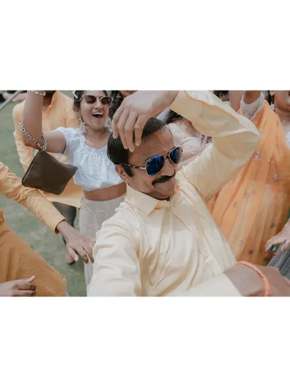 A candid shot of a family member dancing with joy at the Haldi ceremony.