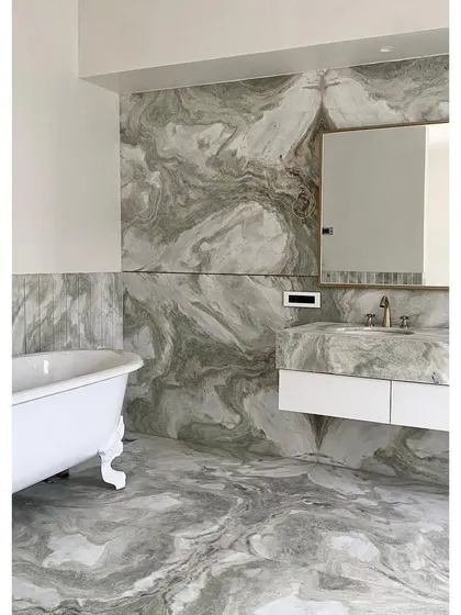 Another bathroom in Bungalow No. 4, featuring a classic clawfoot tub set against floor-to-ceiling marble. This image shows the project in its final stages, just before completion.