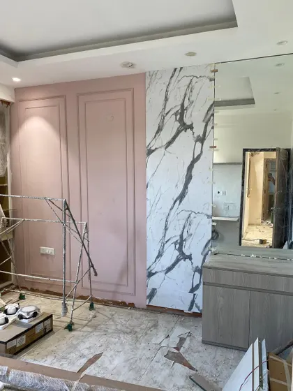 Before: A bedroom at our Logix Blossom County site during the renovation, with initial paneling and marble work underway.