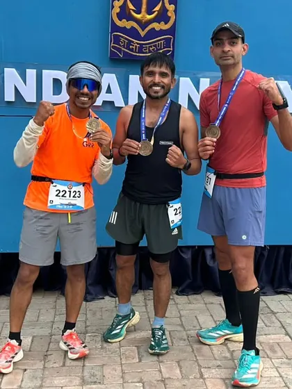 Three of our runners at the Indian Navy Half Marathon, proudly displaying their finisher medals. They crushed it and set personal bests.