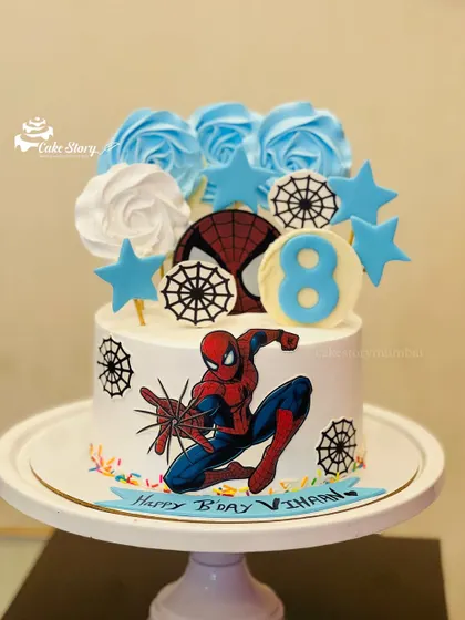 A different angle of the Spider-Man cake, showing the placement of the edible toppers and the number '8' for the birthday boy.