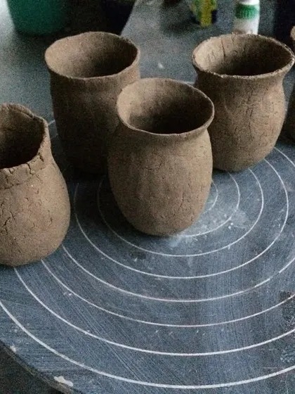 A group of small, hand-pinched pots. Pinching is one of the oldest ways of making pottery, and it creates these beautifully organic, imperfect forms that sit comfortably in your palm.