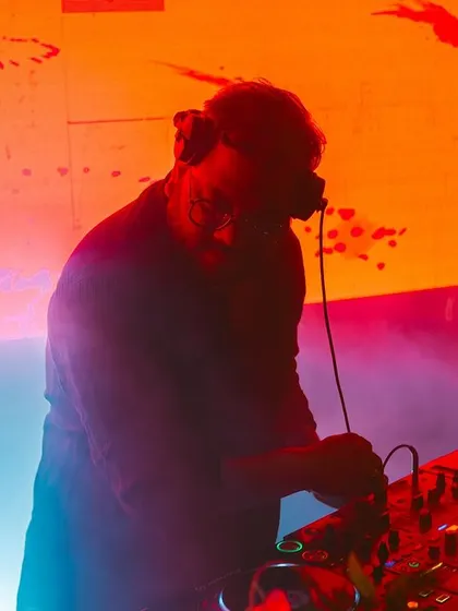 A silhouette shot against a backdrop of vibrant visuals. The combination of audio and visuals is key to the Masala House experience.