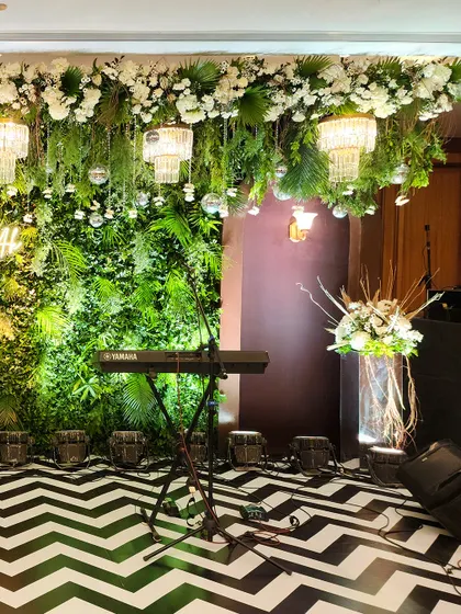 Another view of the green-themed Sangeet stage, highlighting the placement of musical instruments and the overall lush, garden-like feel.
