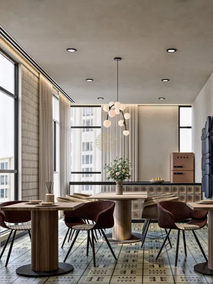 Natural light is essential in a workspace. This view of the office café shows how large windows, paired with light curtains, fill the space with daylight, enhancing the patterned tile floor and warm wood furniture.