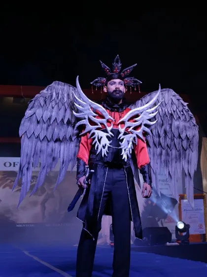 A powerful costume with large grey wings and red accents, part of a fantasy-themed collection.