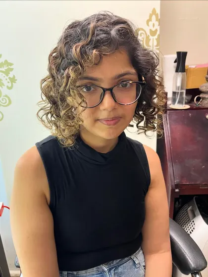 Jeshvi's new curly bob with highlights.