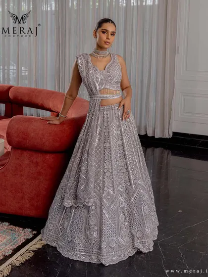 Grace in every gaze, glamour in every thread. This silver-grey lehenga from the 'Ruvaah' collection features intricate sequin detailing and geometric embroidery.
