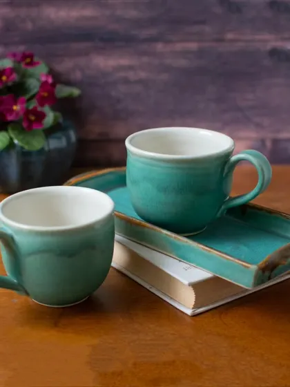 Another view of the turquoise tea cup and tray set. The rich color and glossy finish make it a stunning addition to any tabletop, perfect for serving guests or for a special treat for yourself.