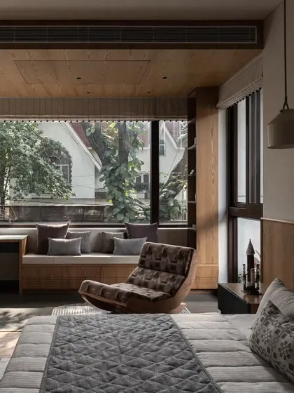 A wider view of the bedroom, showing the balance of natural wood and soft textiles. The design is practical, with plenty of open floor space for play.
