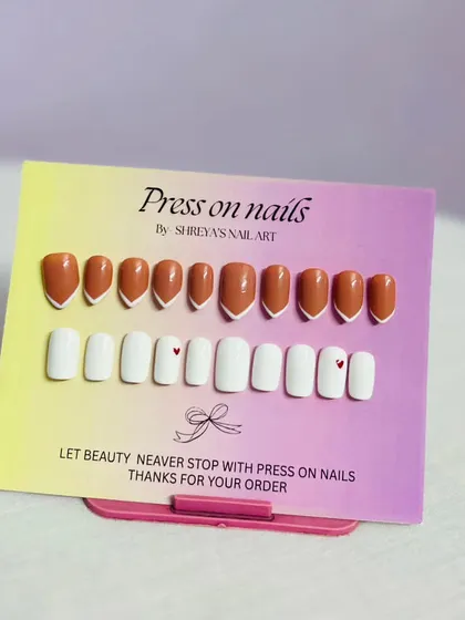 Sometimes simple is best. Here are two minimalist sets, one in a warm terracotta with a V-French tip and another in pure white with a tiny heart accent, perfect for everyday glam.