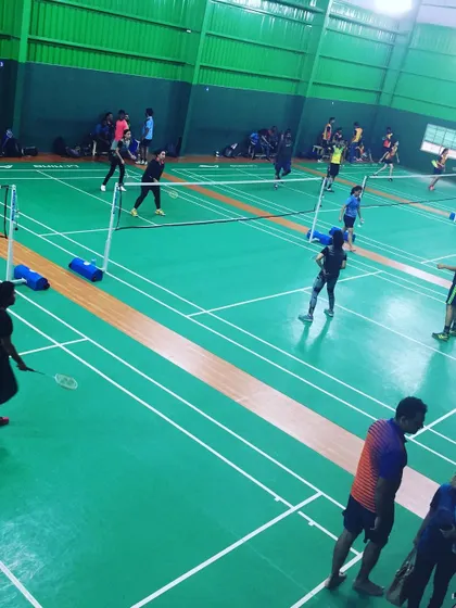 An overhead view of the action during a corporate badminton tournament. This angle highlights the organized flow of the event and the number of participants I can host.