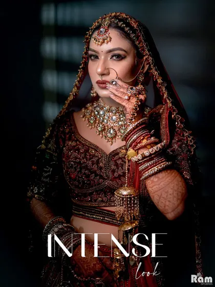 An "Intense Look" from a bride. This close-up portrait uses dramatic lighting to highlight her bold makeup, stunning jewelry, and confident expression, creating a powerful and captivating image.