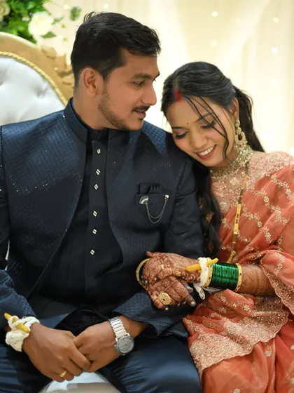 An intimate and sweet moment. The bride's glowing makeup and soft hairstyle create a truly romantic reception look.