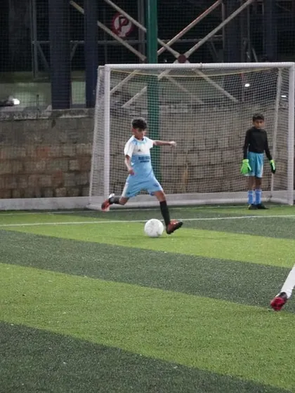 A player takes a powerful shot on goal during a match, showcasing his shooting technique.