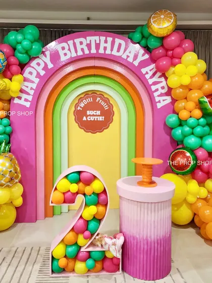 A full view of the "Twottii Frutti" birthday setup, showing the rainbow arch, balloon-filled number two, and colorful fruit-themed balloon garlands. This theme is perfect for a bright and cheerful celebration.