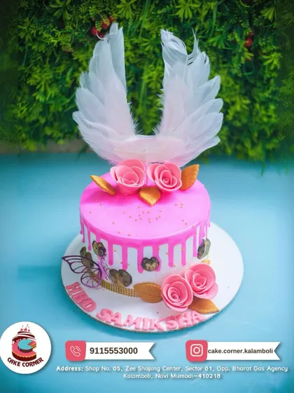 A heavenly angel wings cake in pink. The large white feather wings and delicate roses create a truly divine and beautiful birthday cake.