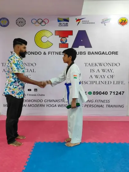 A handshake for a new blue belt.