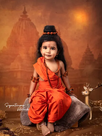 A beautiful portrait of a little girl styled as Sita, embodying grace and serenity. The rich colors of the backdrop and her traditional attire create a timeless and artistic image.