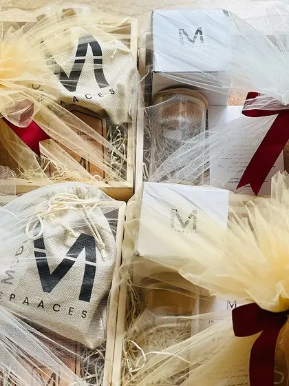 Corporate hampers beautifully wrapped in tulle with a red ribbon. This shows how I prepare bulk orders for a festive and presentable delivery.