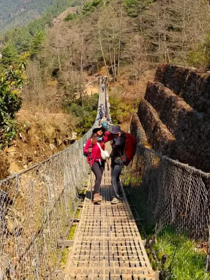 Crossing one of the high suspension bridges on the way to Everest Base Camp. These bridges are an iconic and thrilling part of the trek, connecting remote Sherpa villages in the Khumbu valley.
