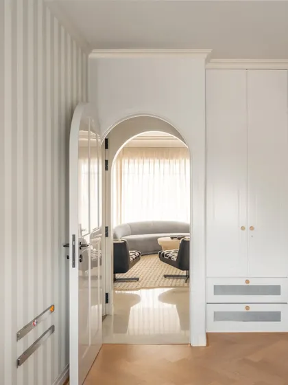 A view from the children's area into the main living space, showing the seamless flow and consistent design language throughout the home.