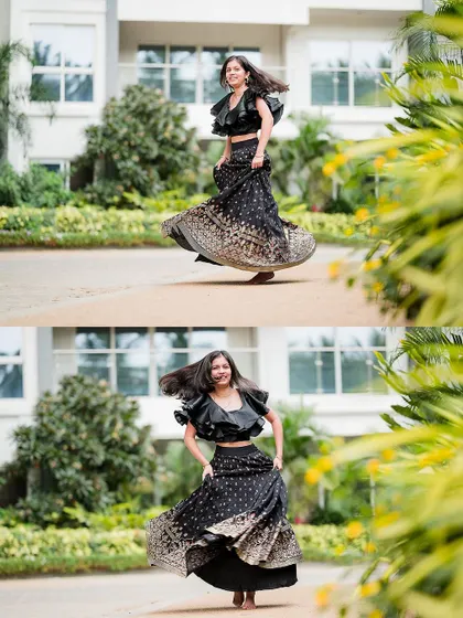A young woman twirls in her beautiful lehenga, her hair flying, during an outdoor family photoshoot.