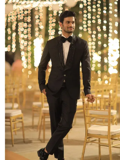 For a formal reception or black-tie event, I designed this sharp black tuxedo. The standout feature is the custom embroidered shawl lapel, which adds a unique, luxurious detail to a timeless silhouette.
