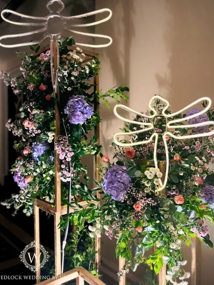For this whimsical garden reception, we used glowing LED dragonflies and birds nestled among pastel floral arrangements. These unique lighting elements added a touch of magic and sophistication to the decor.