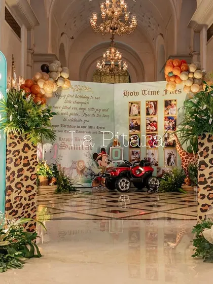 The grand hallway entrance to the safari party, framed by illuminated character boards and leading to the main event.