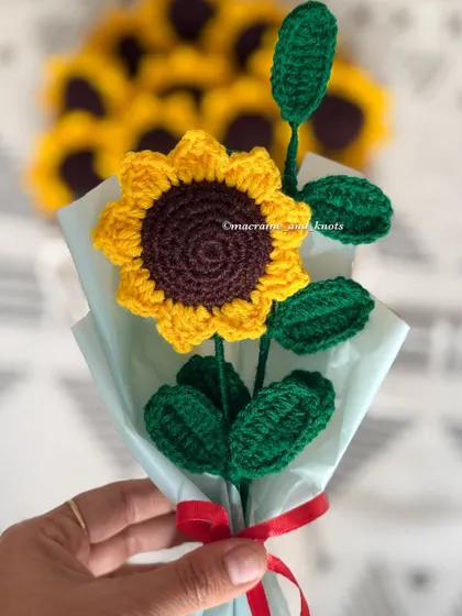 A mini bouquet featuring a single crochet sunflower. This is a perfect, small token of appreciation for your friends or colleagues.