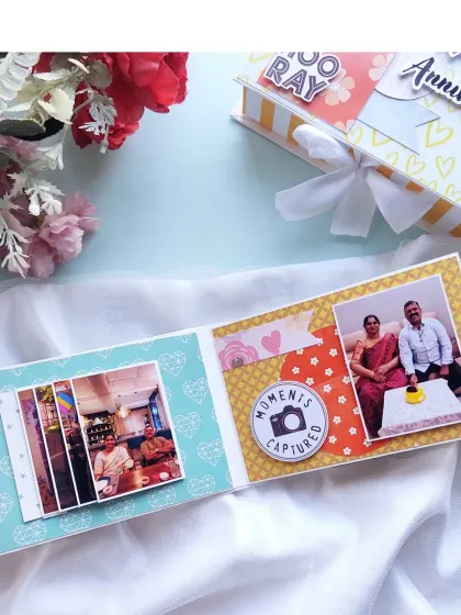 An anniversary scrapbook page with a waterfall card and a "moments captured" embellishment, celebrating a 25th anniversary.