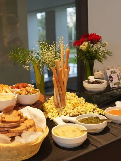 A simple yet elegant dip station with various kinds of hummus, breadsticks, and fresh bread. This is a versatile component of our grazing tables that appeals to all palates.