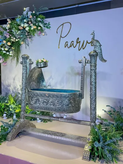 A closer look at the ornate silver cradle, a stunning centerpiece for a traditional naming ceremony.