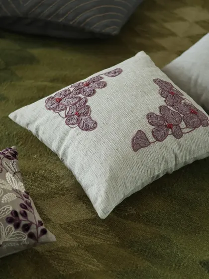 From our 'Ethereal Rose' collection, this cushion conjures images of a romantic serenade. The design pairs the warm, inviting tones of wine with the delicate beauty of embroidered rose motifs on a textured base.