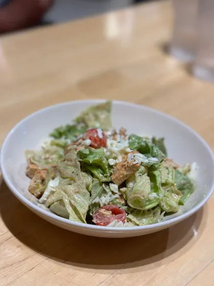 A fresh and healthy chicken salad, packed with greens, tomatoes, and protein. It's a great choice for a light lunch or a post-workout meal.