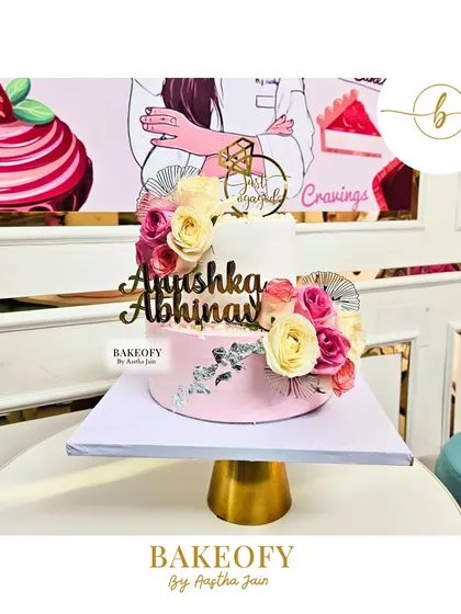 I made this 2.5 kg chocolate mousse cake for an engagement party. It features a two-tone pink and white design, decorated with elegant roses and a touch of silver for a sophisticated look.