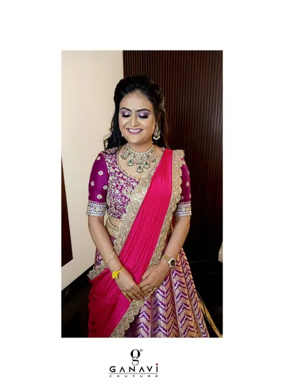 Our client Kusuma looks marvelous in this beautiful Banarasi silk half-saree. The rich purple and pink combination, paired with a heavily embroidered blouse, is a definite head-turner.