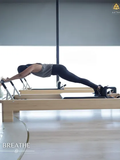 A full body plank on the Reformer. This exercise challenges your core stability and shoulder strength, all while maintaining a long, straight line from head to heels.