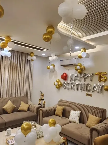 Another angle of the elegant 75th birthday home setup, showing the "Happy 75th Birthday" foil balloons as the main centerpiece.