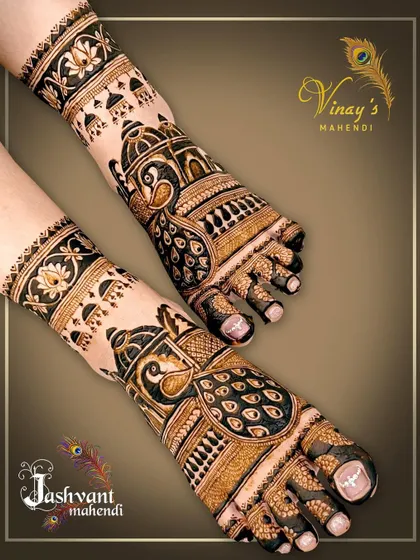 This striking feet design features large peacock motifs with detailed feather work. The jhumka-like patterns on the ankles add a festive touch.