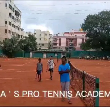 A wide shot of the clay courts at Trisha's Pro Tennis Academy during a busy session. We offer group sessions that keep the vibe lively and supportive for all our players.