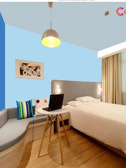 A color visualizer mock-up showing a blue accent wall in a guest room. Our free color consultation can help you explore endless possibilities and choose a palette that perfectly reflects your personal style.