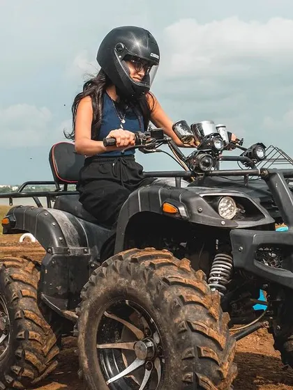A close-up shot showcasing the rugged ATV and a focused rider ready to take on the course. We provide all necessary safety gear, including helmets, for a worry-free experience.