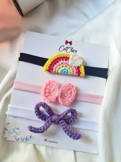 Introducing our handmade crochet newborn headbands! This set of three includes a rainbow, a pink bow, and a purple bow design.