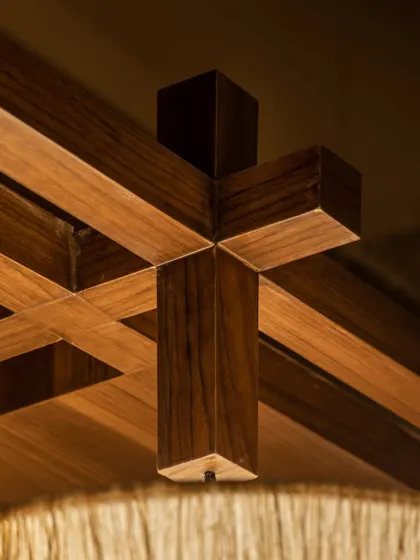 Craftsmanship is at the heart of our work. This close-up from the Grid Pavilion restaurant shows the intricate joinery of the custom wooden ceiling grid, a detail that adds structural beauty and a sense of order to the dining space.